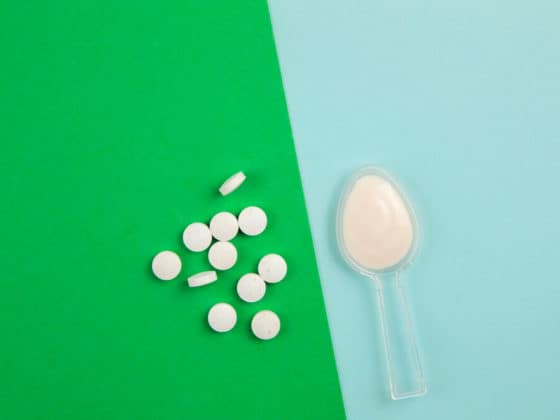 Antibiotics with probiotics against a blue and green background.