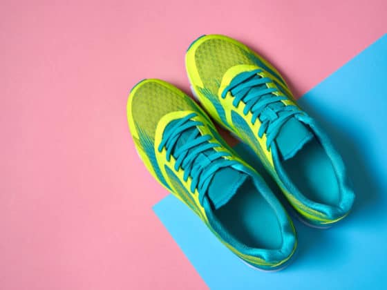 Pair of sport shoes on colorful background. New sneakers on pink and blue pastel background. Overhead shot of running shoes. Top view, flat lay